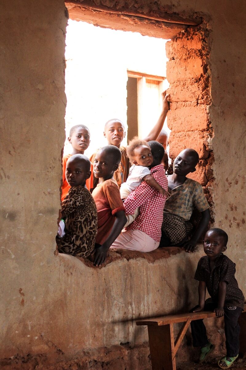 Photo by Hanna Morris children sitting on window