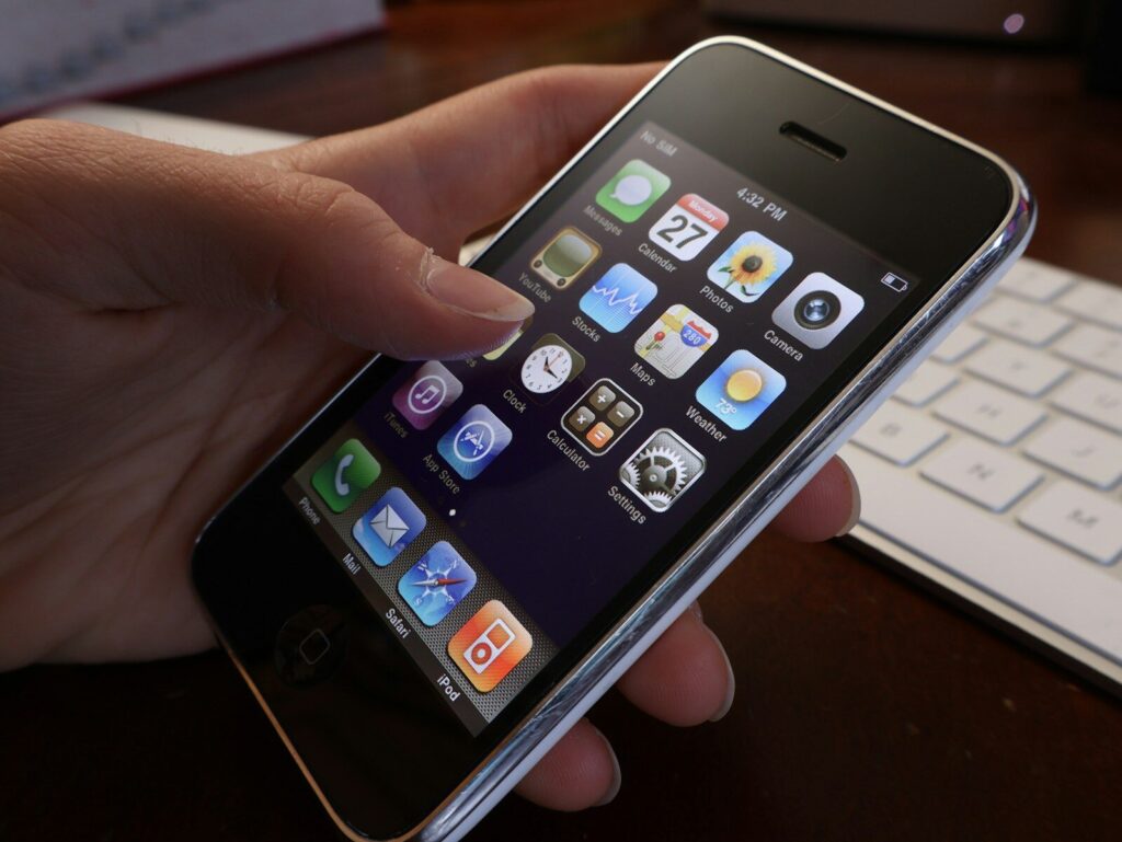 A person holding an iPhone in their hand